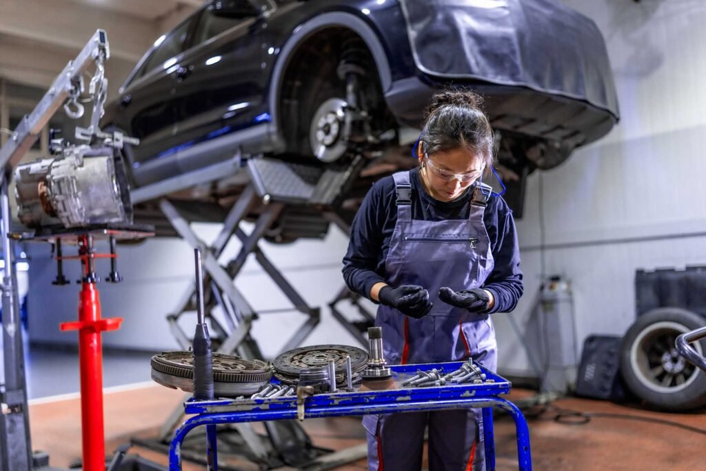 female-mechanic-working-on-car-parts-in-auto-repai-FN5XPPV.jpg